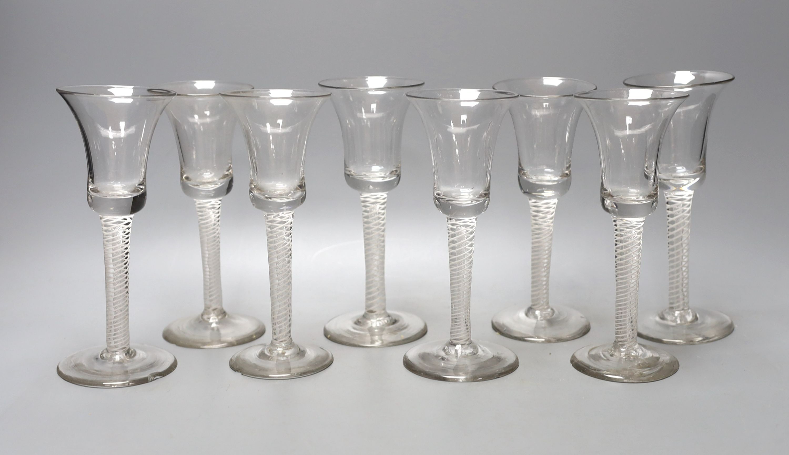 A set of eight George lll double-series opaque-twist wine glasses, 17cm, some chips